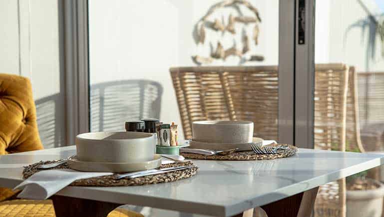 Breakfast table at Villa Marine Guest House in Pringle Bay with morning sunlight and ocean views
